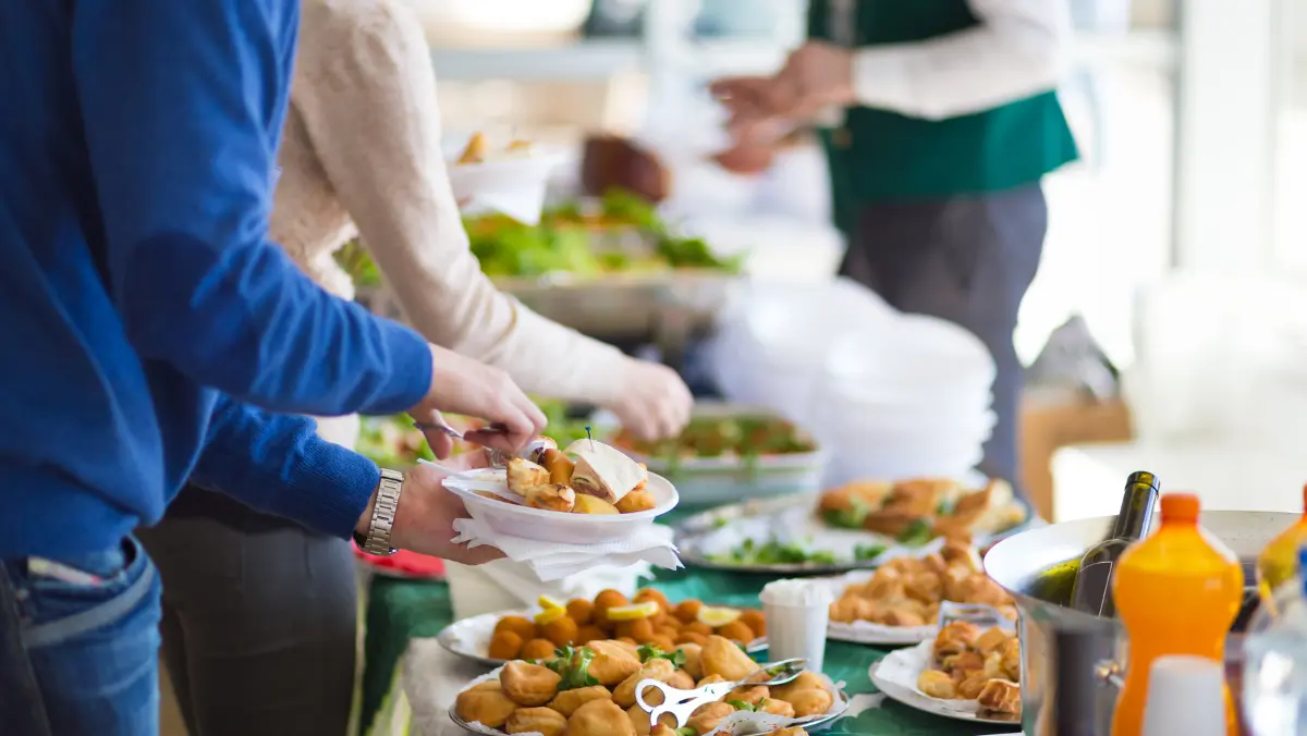 People serving themselves at a buffet.