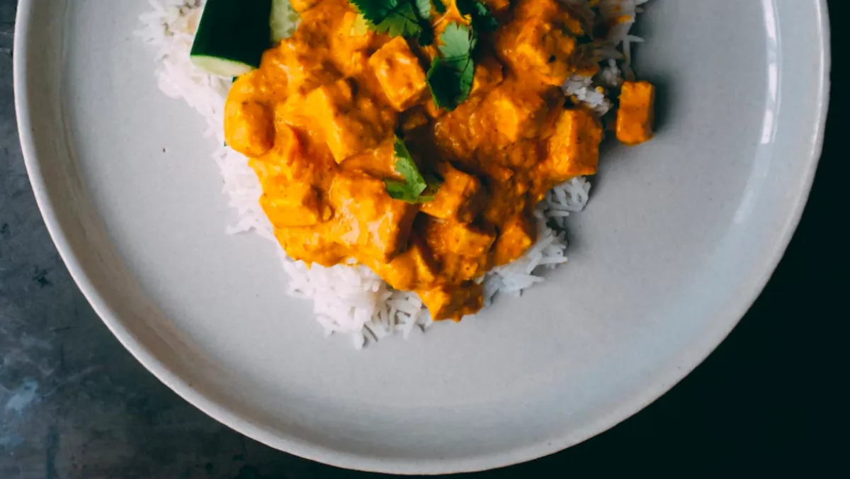 Plate with some curry over rice.
