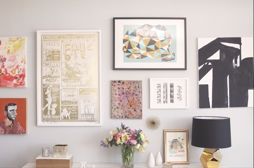 Gallery wall with framed artwork above console in freshly cleaned rental property