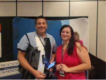 A person and person standing in front of a blue and white wallAI-generated content may be incorrect.