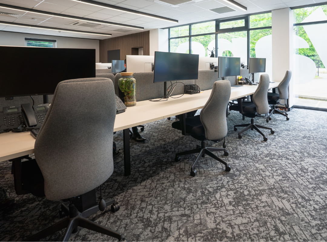 8 person bench desk in large office with white tops and black frames