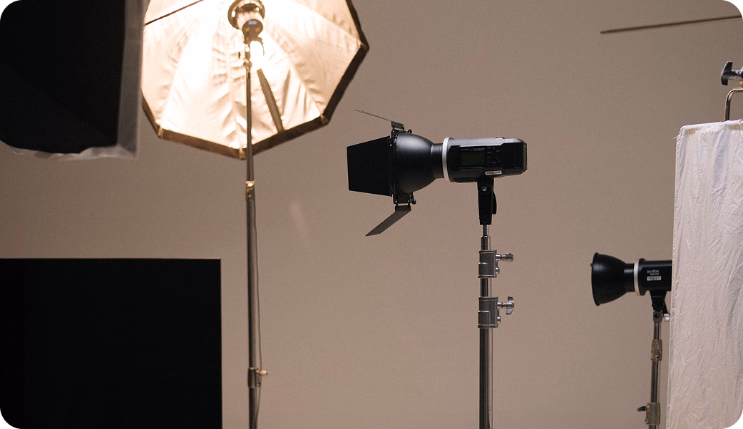 Photo studio set with softbox and spotlight lighting equipment ready for a production shoot.