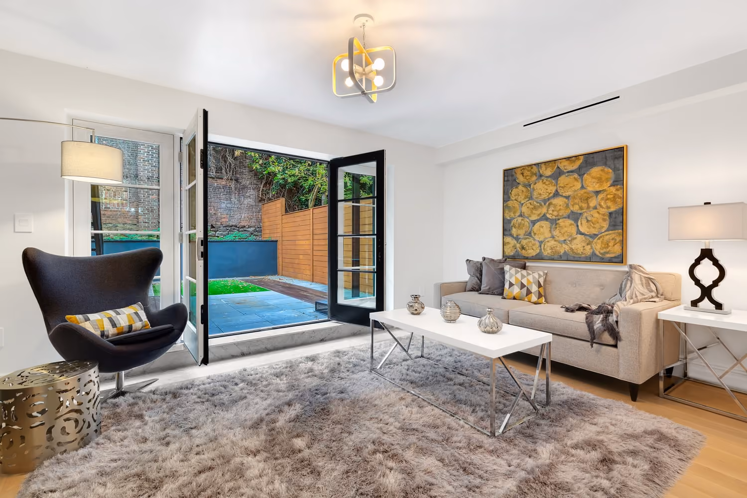 Family room with curved furniture from a Brooklyn apartment renovation by Gallery KBNY