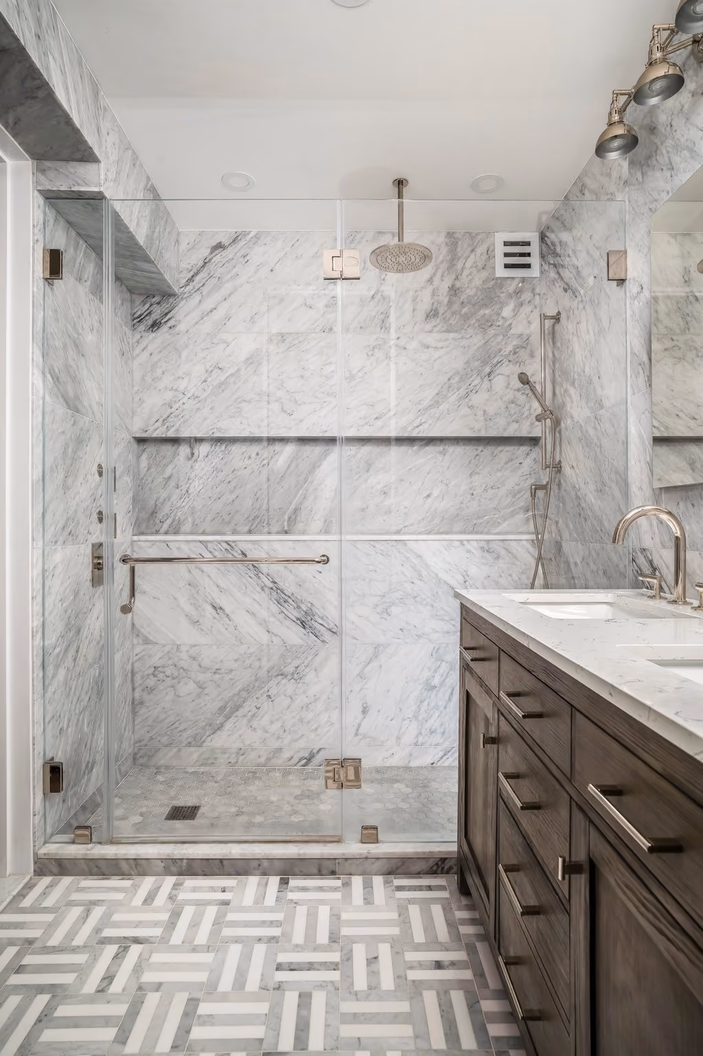 Bathroom with extended shower space in a NYC apartment renovation by Gallery KBNY