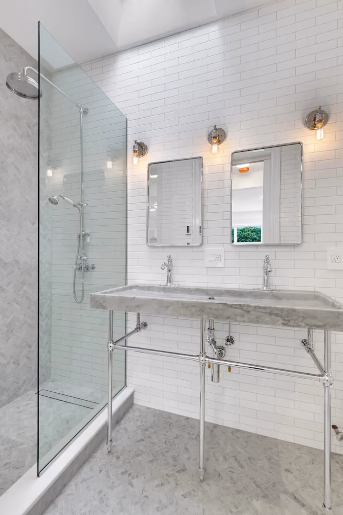 NYC bathroom remodel with light-toned, glossy surfaces by Gallery KBNY 