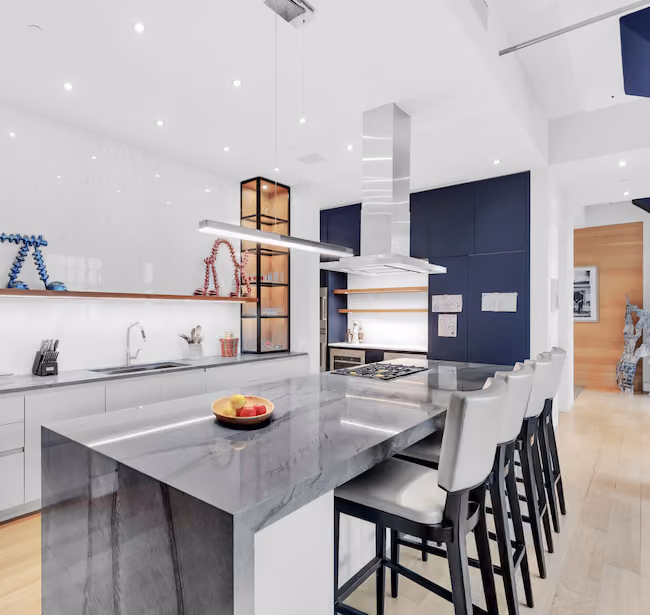 Renovated kitchen with book-matched marble backsplash at Sky Lofts, 145 Hudson Street, in Tribeca, Manhattan, by Gallery KBNY