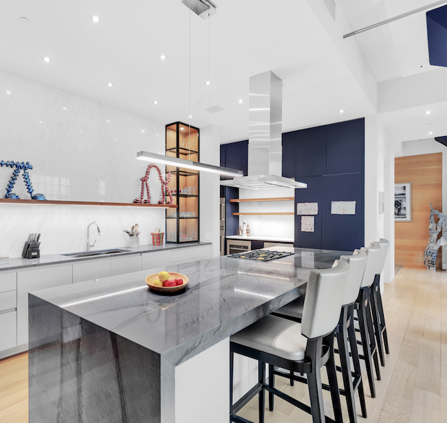 Renovated kitchen with book-matched marble backsplash at Sky Lofts, 145 Hudson Street, in Tribeca, Manhattan, by Gallery KBNY