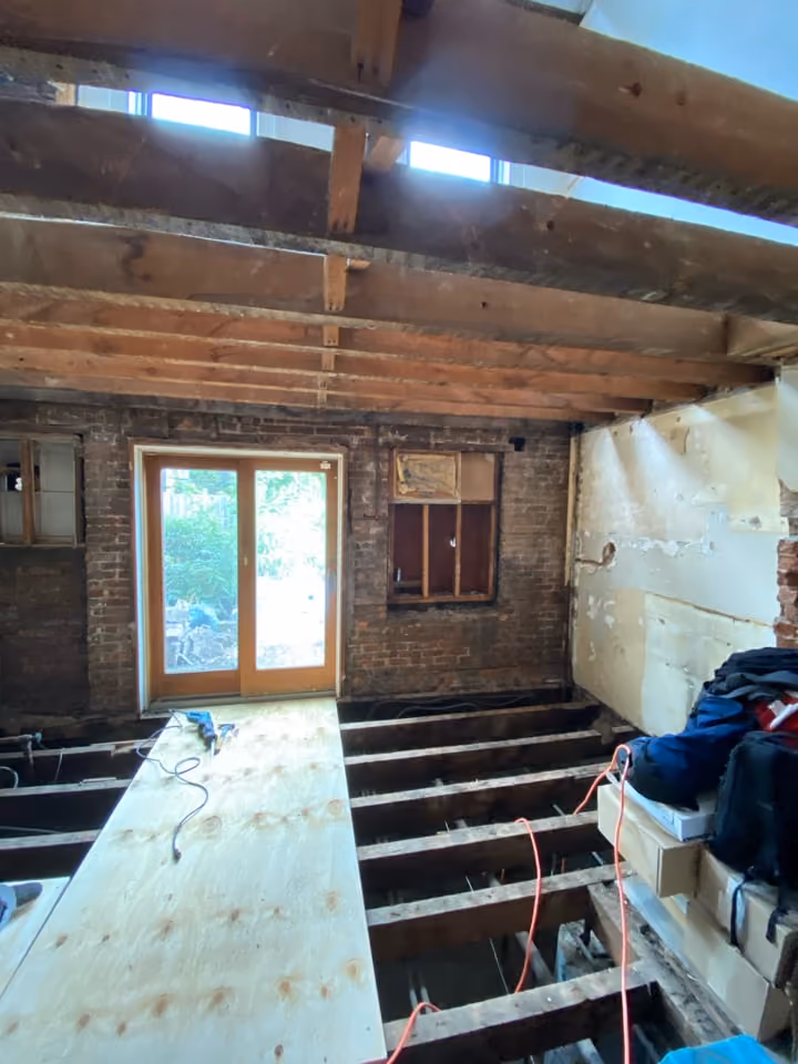 Framed room with new window opening during a Carroll Gardens brownstone renovation at 347 President Street, Brooklyn, by Gallery KBNY