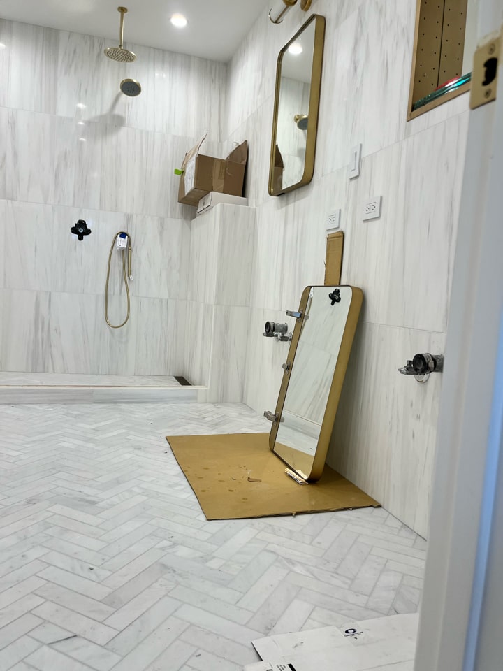 Marble shower with brass fixtures nearing completion in a Carroll Gardens brownstone at 347 President Street, Brooklyn, by Gallery KBNY