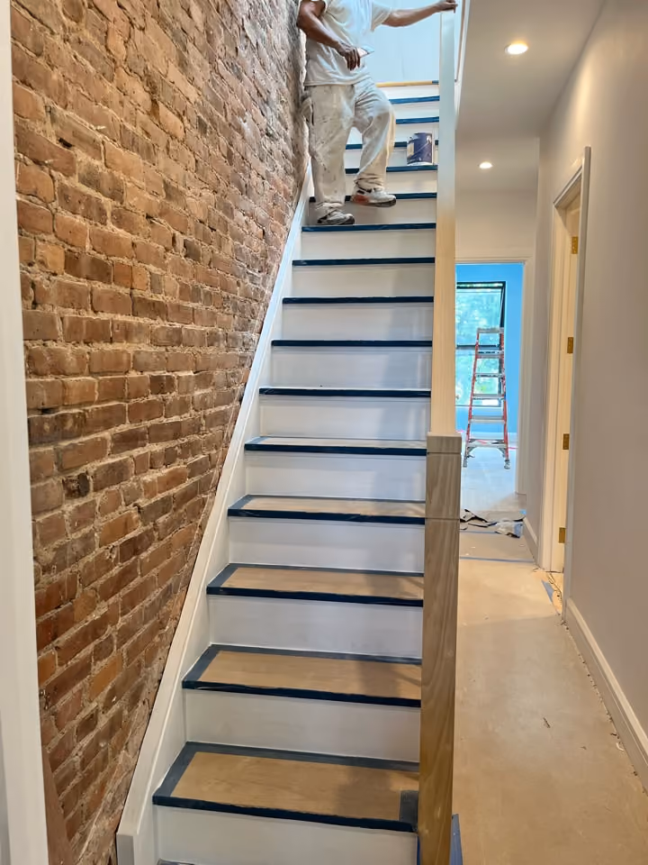 New staircase against exposed brick during a Carroll Gardens brownstone renovation at 347 President Street, Brooklyn, by Gallery KBNY