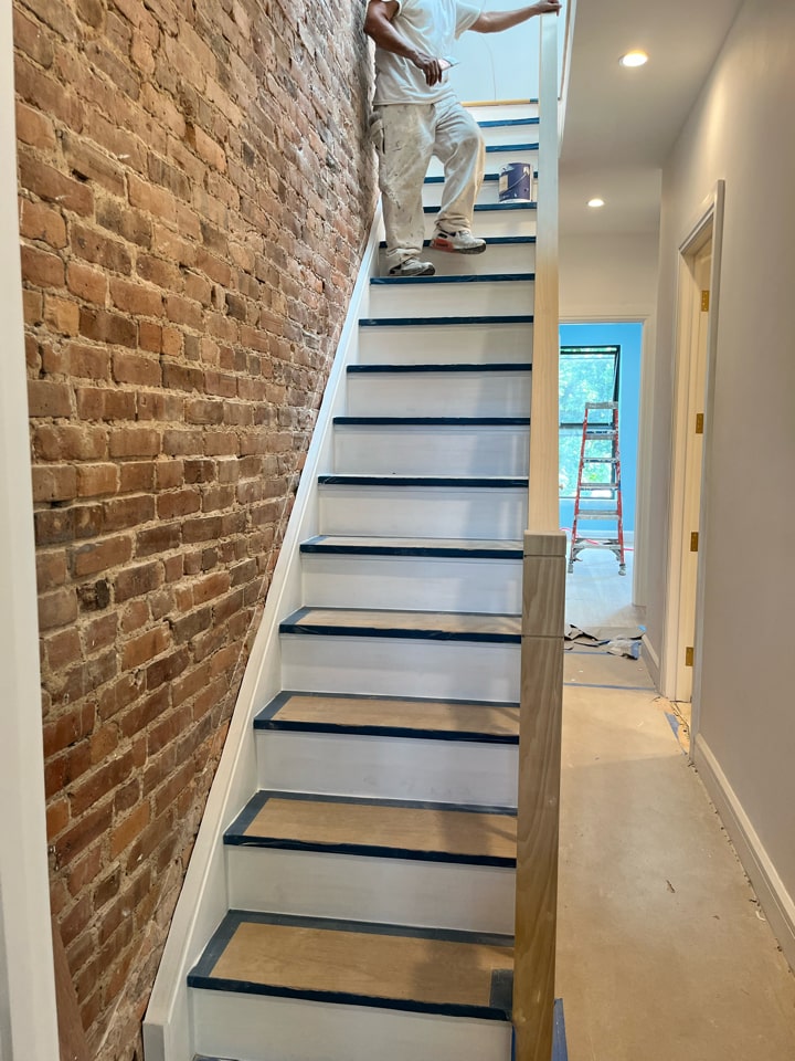New staircase against exposed brick during a Carroll Gardens brownstone renovation at 347 President Street, Brooklyn, by Gallery KBNY