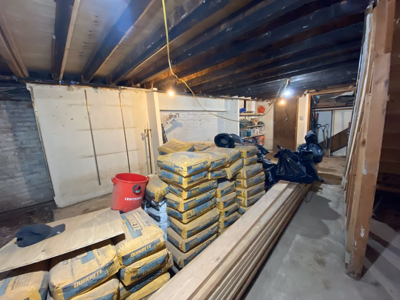 Cellar level with staged materials during construction of a Carroll Gardens brownstone renovation at 347 President Street, Brooklyn, by Gallery KBNY