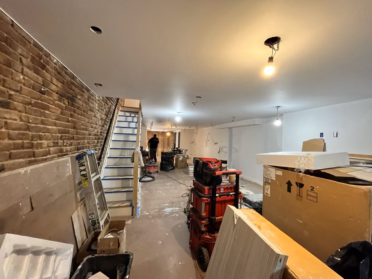 Gutted parlor floor with original staircase during a Carroll Gardens brownstone renovation at 347 President Street, Brooklyn, by Gallery KBNY