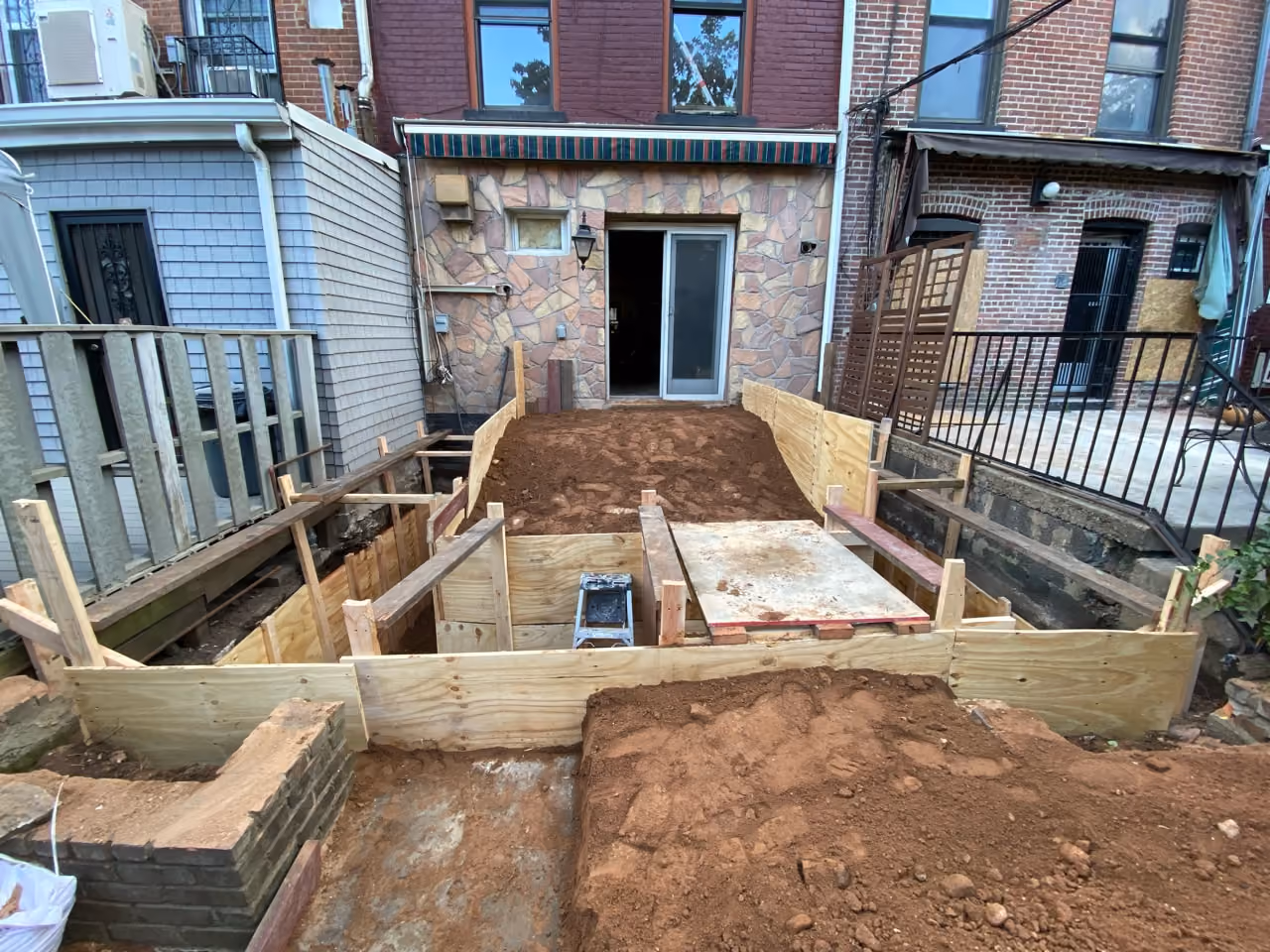 Rear yard excavation and formwork during a Carroll Gardens brownstone renovation at 347 President Street, Brooklyn, by Gallery KBNY