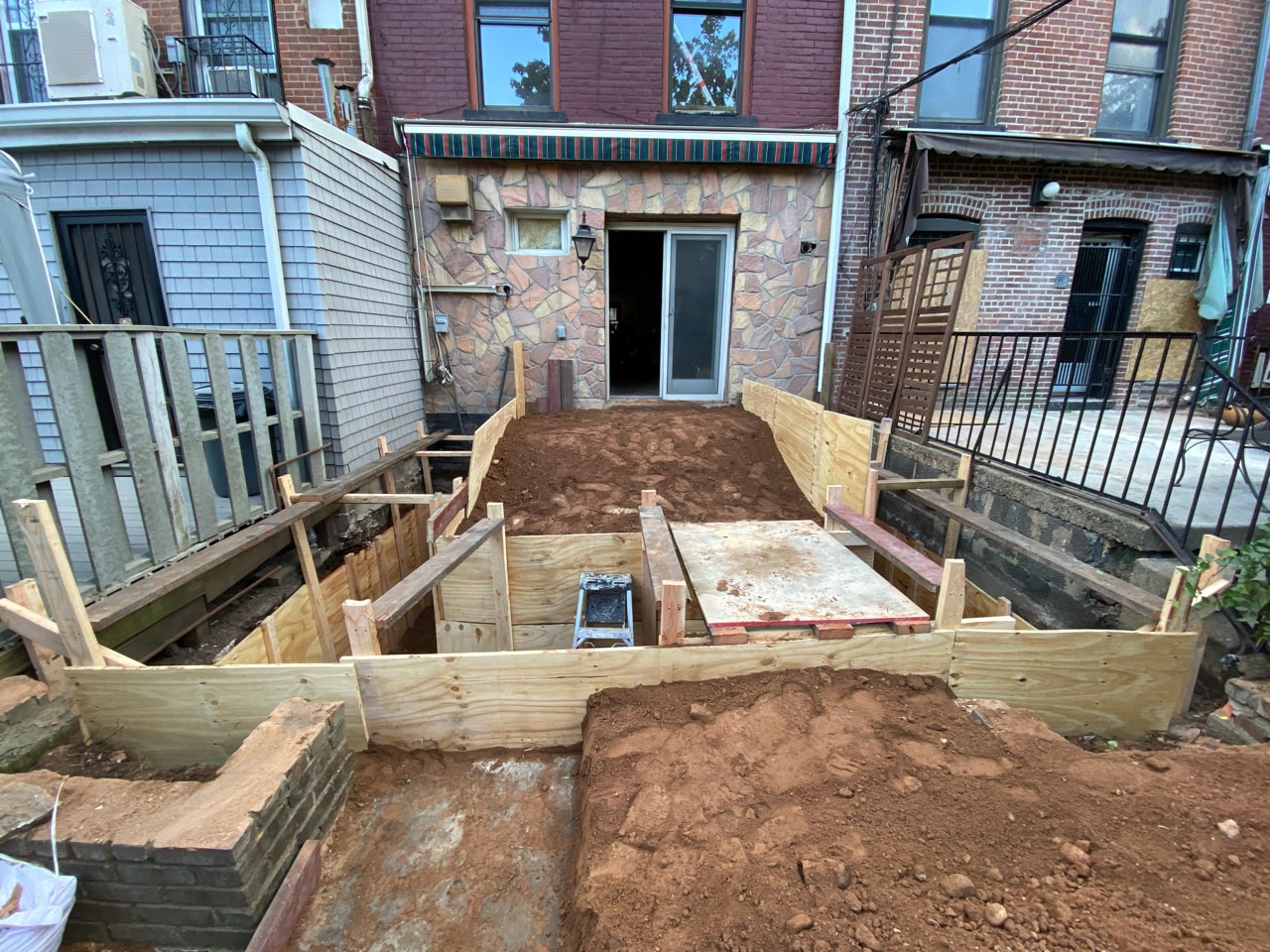 Rear yard excavation and formwork during a Carroll Gardens brownstone renovation at 347 President Street, Brooklyn, by Gallery KBNY