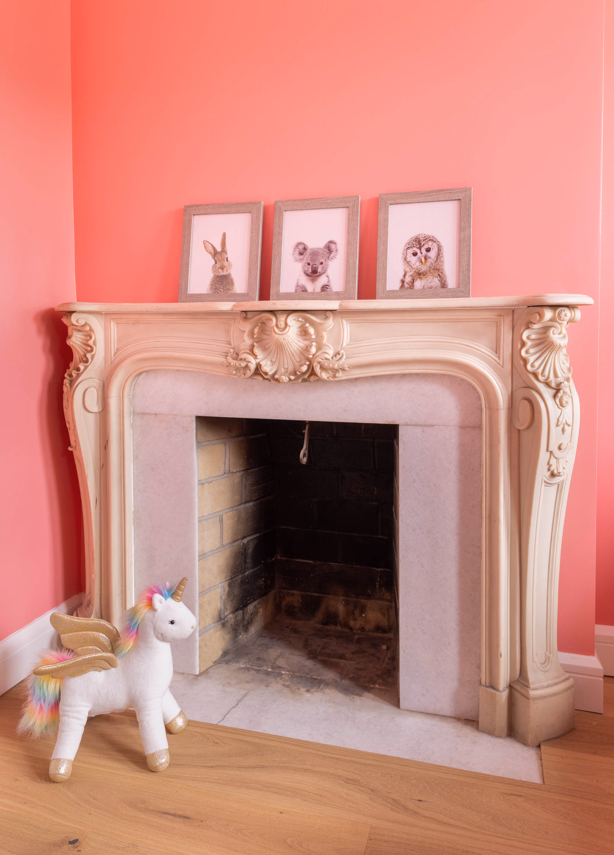 Bedroom with restored ornate fireplace and pink walls in a Carroll Gardens brownstone at 347 President Street, Brooklyn, by Gallery KBNY