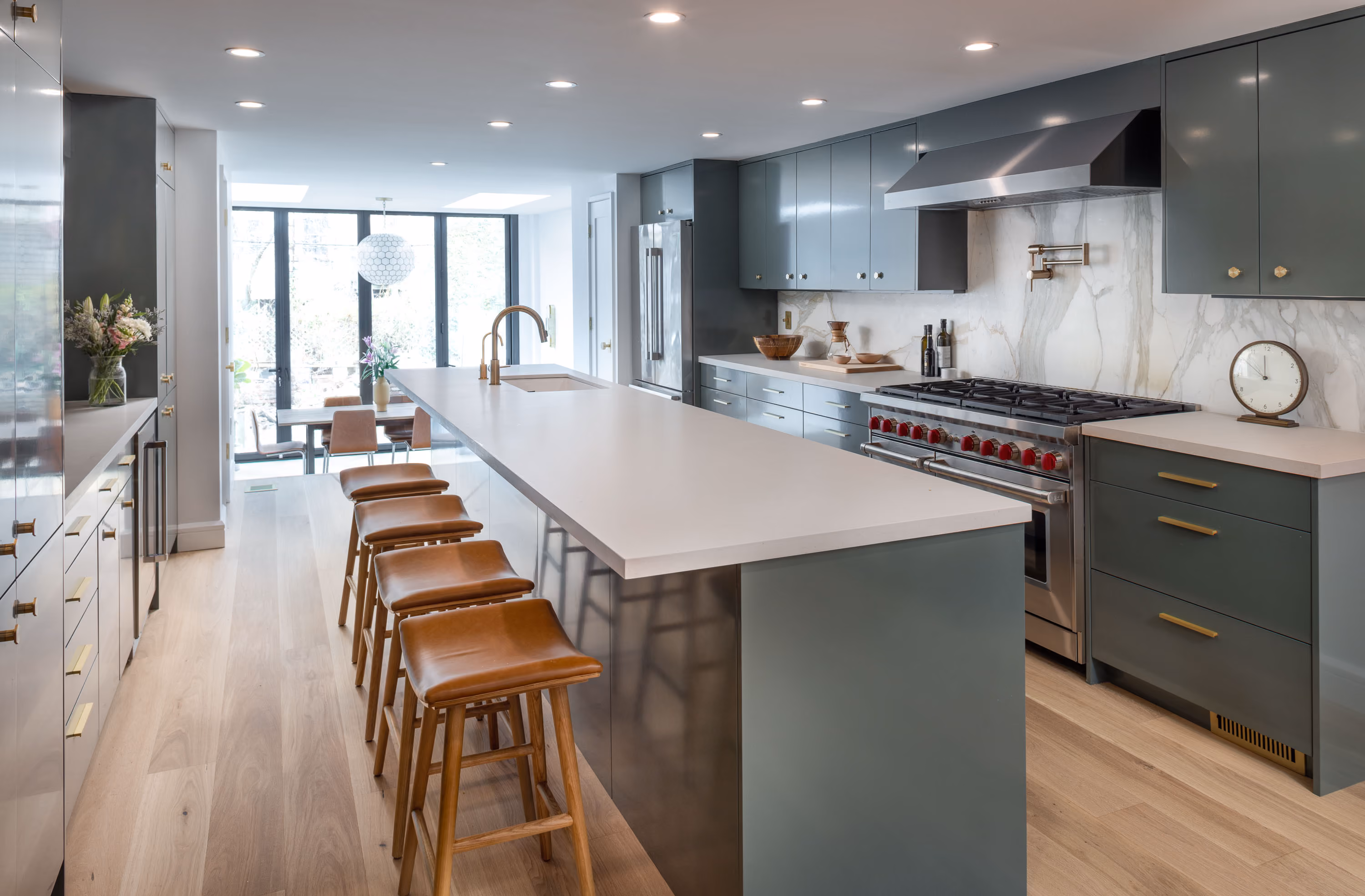 Renovated kitchen with island and green cabinetry in a Carroll Gardens brownstone at 347 President Street, Brooklyn, by Gallery KBNY