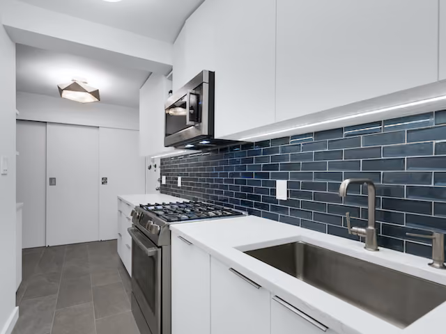 Renovated interior of a post-war co-op kitchen at The Norville House at 13 West 13th Street in Greenwich Village, Manhattan, by Gallery KBNY (view 1)