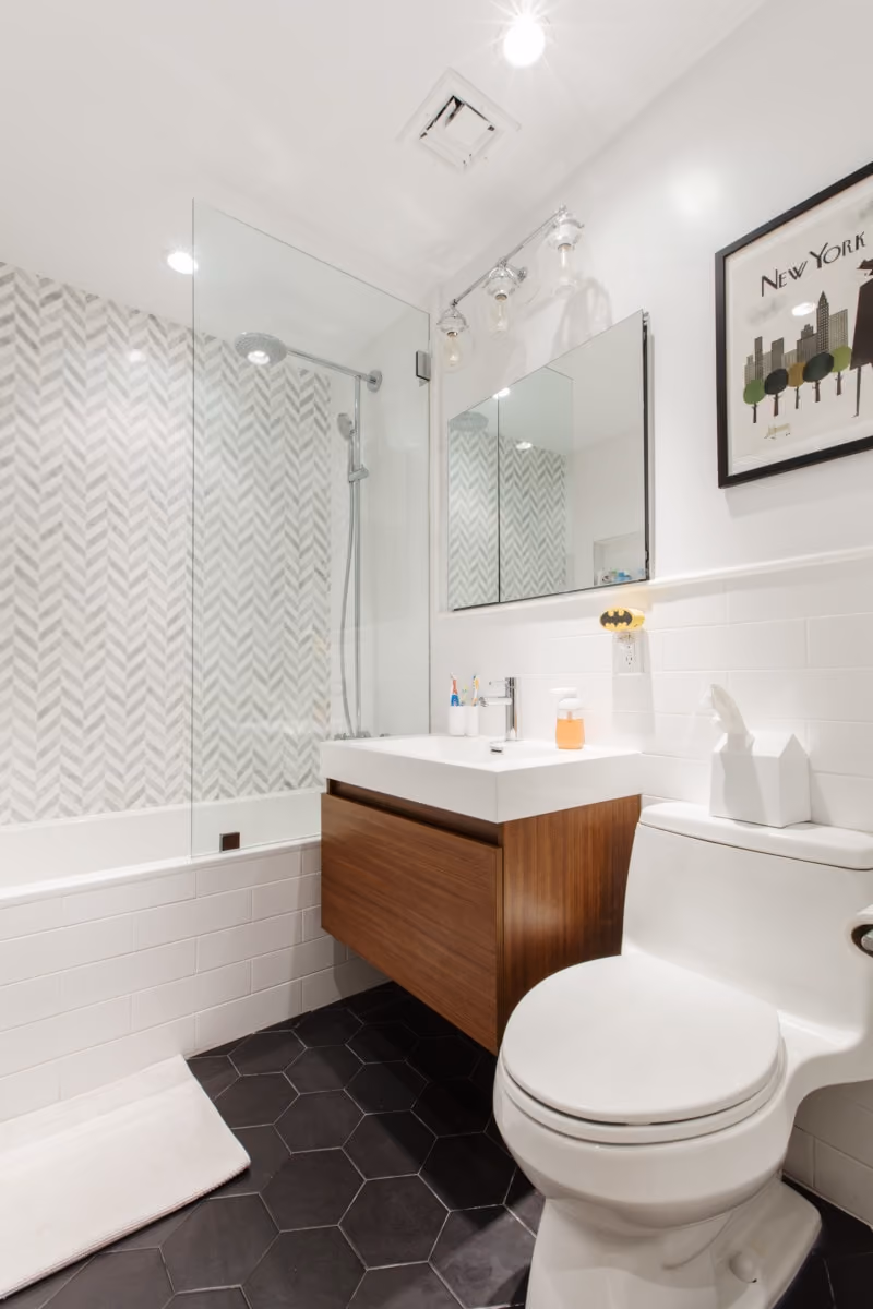 Renovated interior of a farmhouse-style co-op kitchen, bathroom, and laundry at Red Hook, Brooklyn, by Gallery KBNY (bathroom)