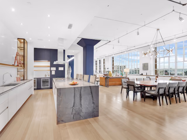 Renovated loft kitchen and dining with city views at Sky Lofts, 145 Hudson Street, in Tribeca, Manhattan, by Gallery KBNY