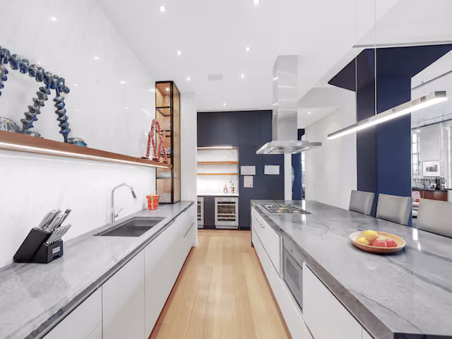 Renovated loft kitchen with marble countertops at Sky Lofts, 145 Hudson Street, in Tribeca, Manhattan, by Gallery KBNY