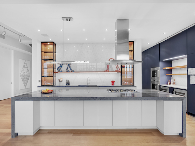 Kitchen island with waterfall marble and open shelving at Sky Lofts, 145 Hudson Street, in Tribeca, Manhattan, by Gallery KBNY