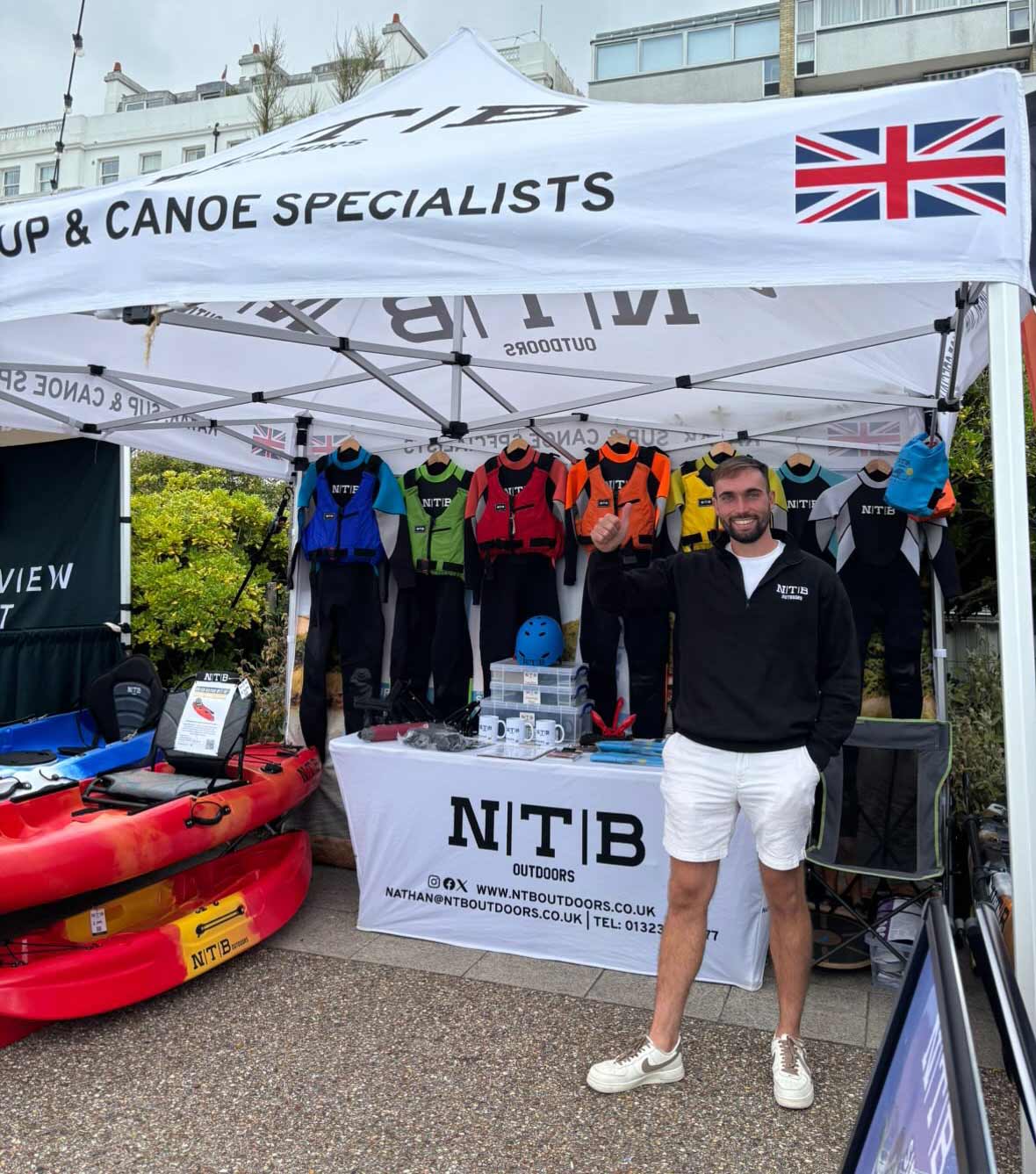 Owner of NTB Outdoors, Nathan Bates, standing in an NTB sales tent