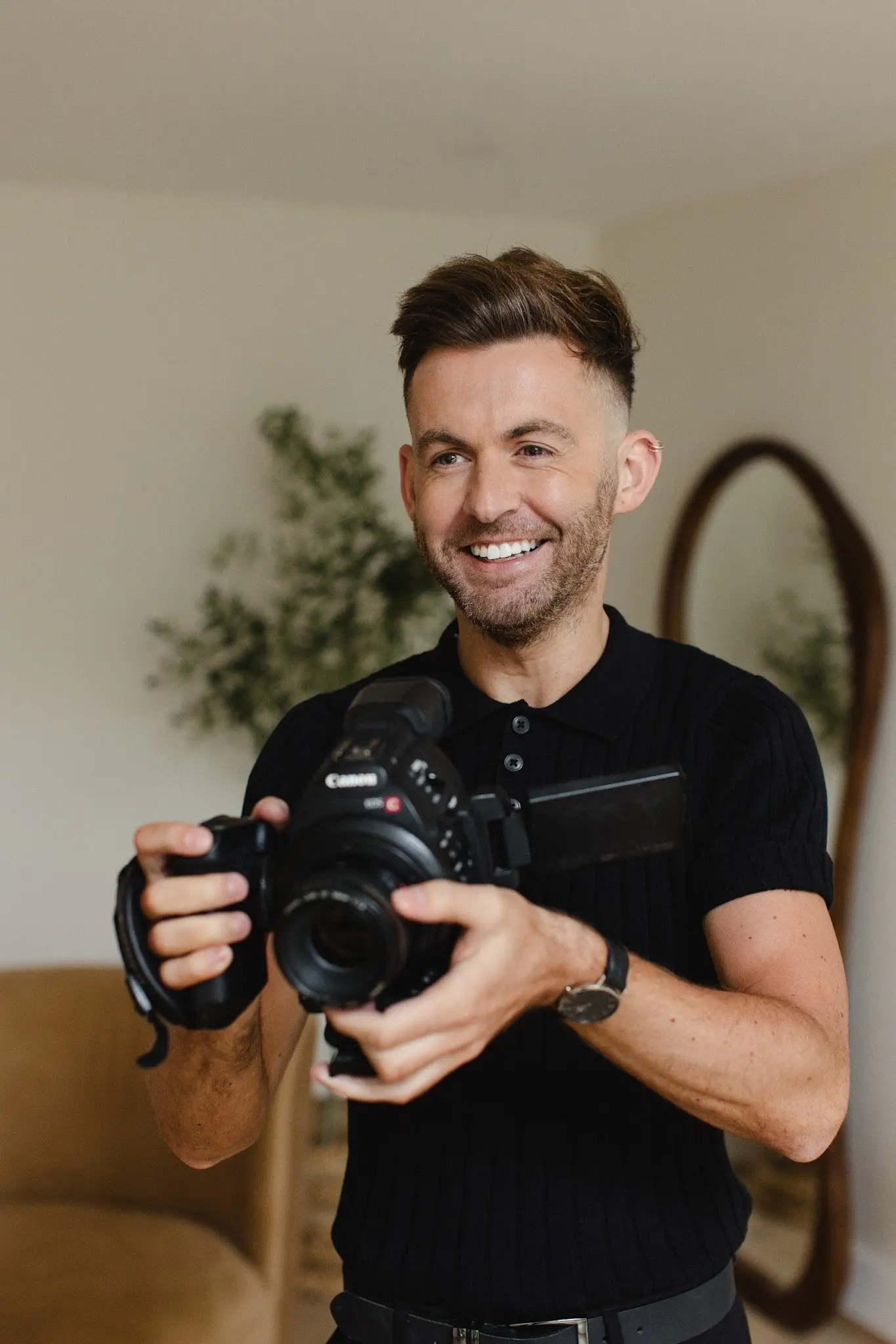 Ben from Down the Aisle videography smiling while holding his camera
