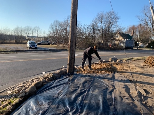 Professional decorative stone mulch installation enhancing a residential landscape in Uniontown, OH.