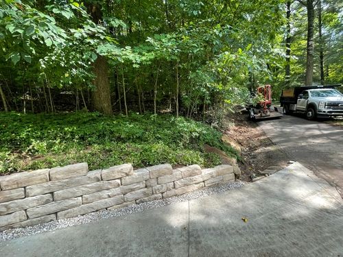 Custom-built retaining wall providing structural support and enhanced landscape design in Uniontown, OH.