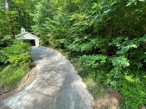 Multi-tiered retaining wall system stabilizing a sloped yard while enhancing curb appeal.