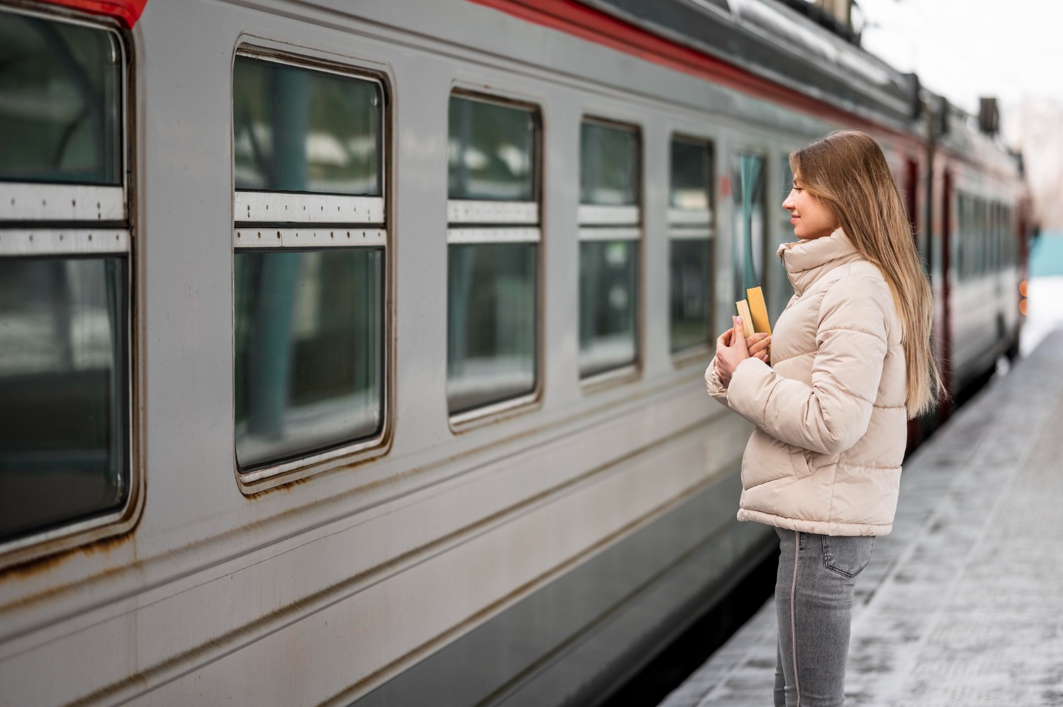 Lady waiting at train station with train