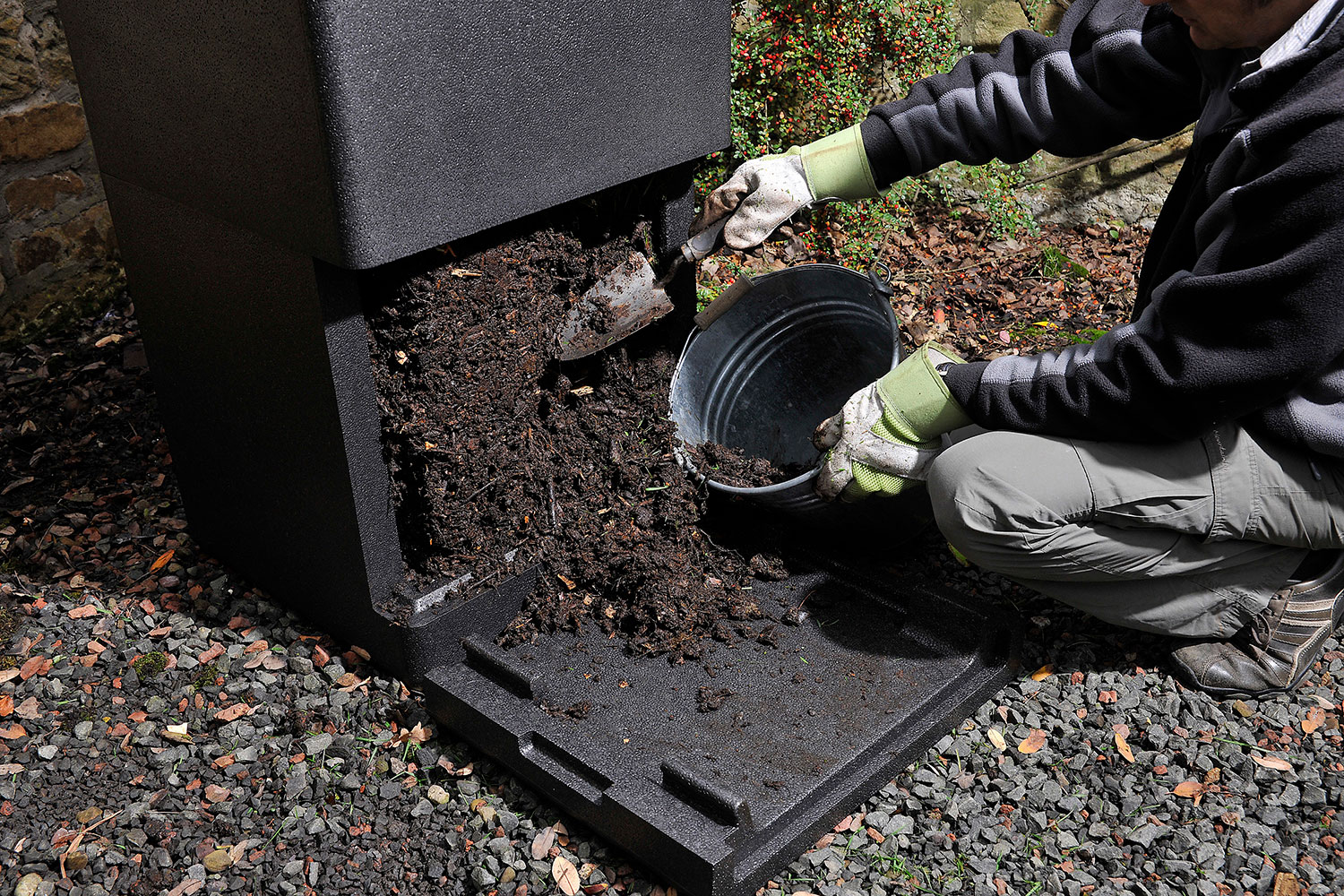 Finished compost being removed from the base hatch of a HOTBIN composter