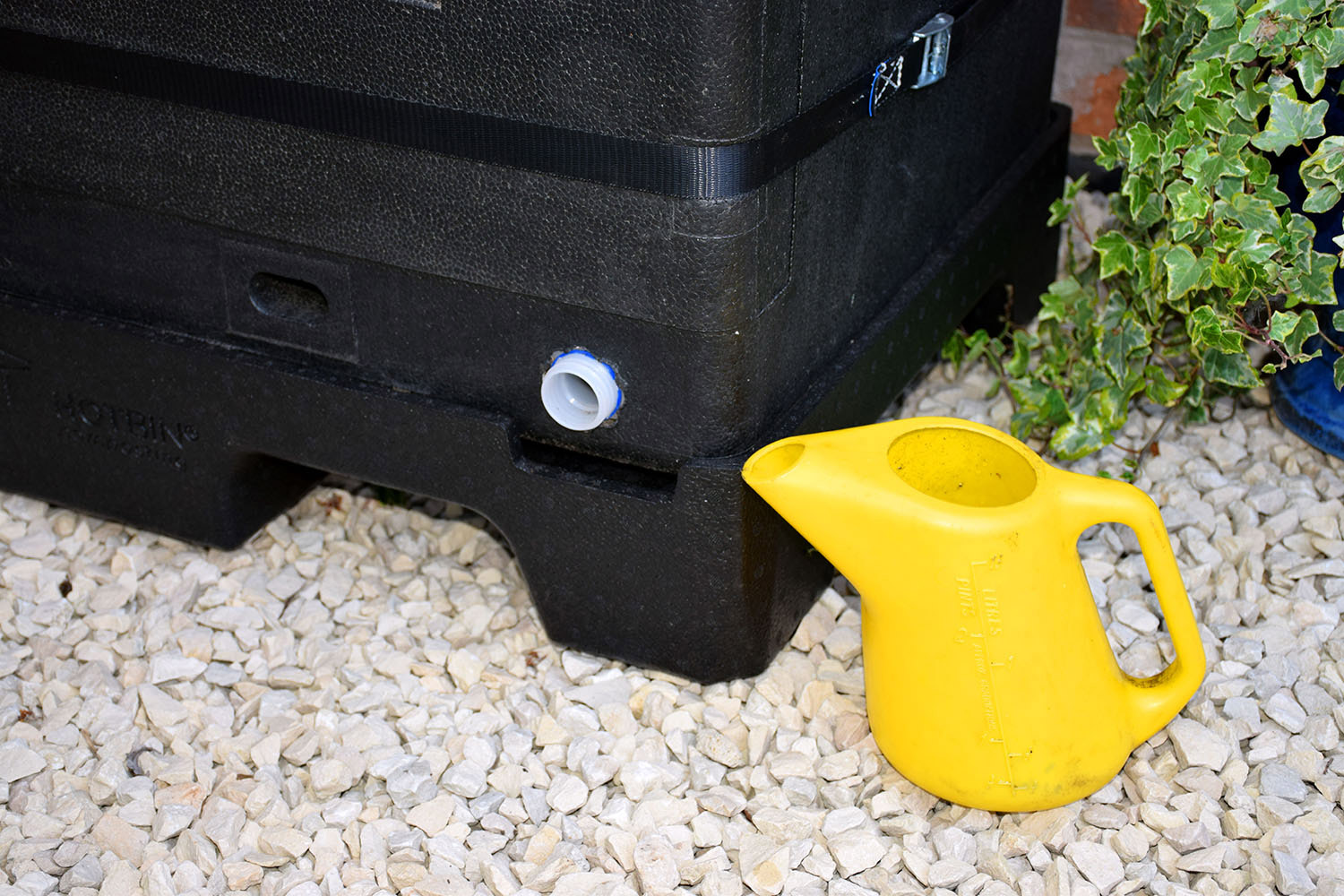 Liquid fertiliser draining from the base tap of a HOTBIN on its plinth