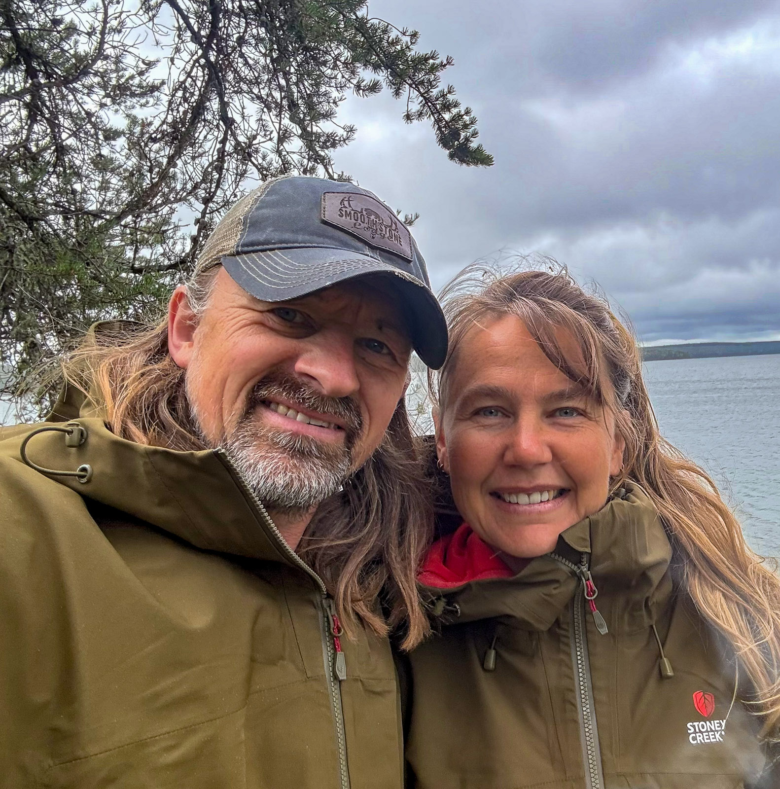 A selfie of Lyndon and Carolyn Gliege next to a creek
