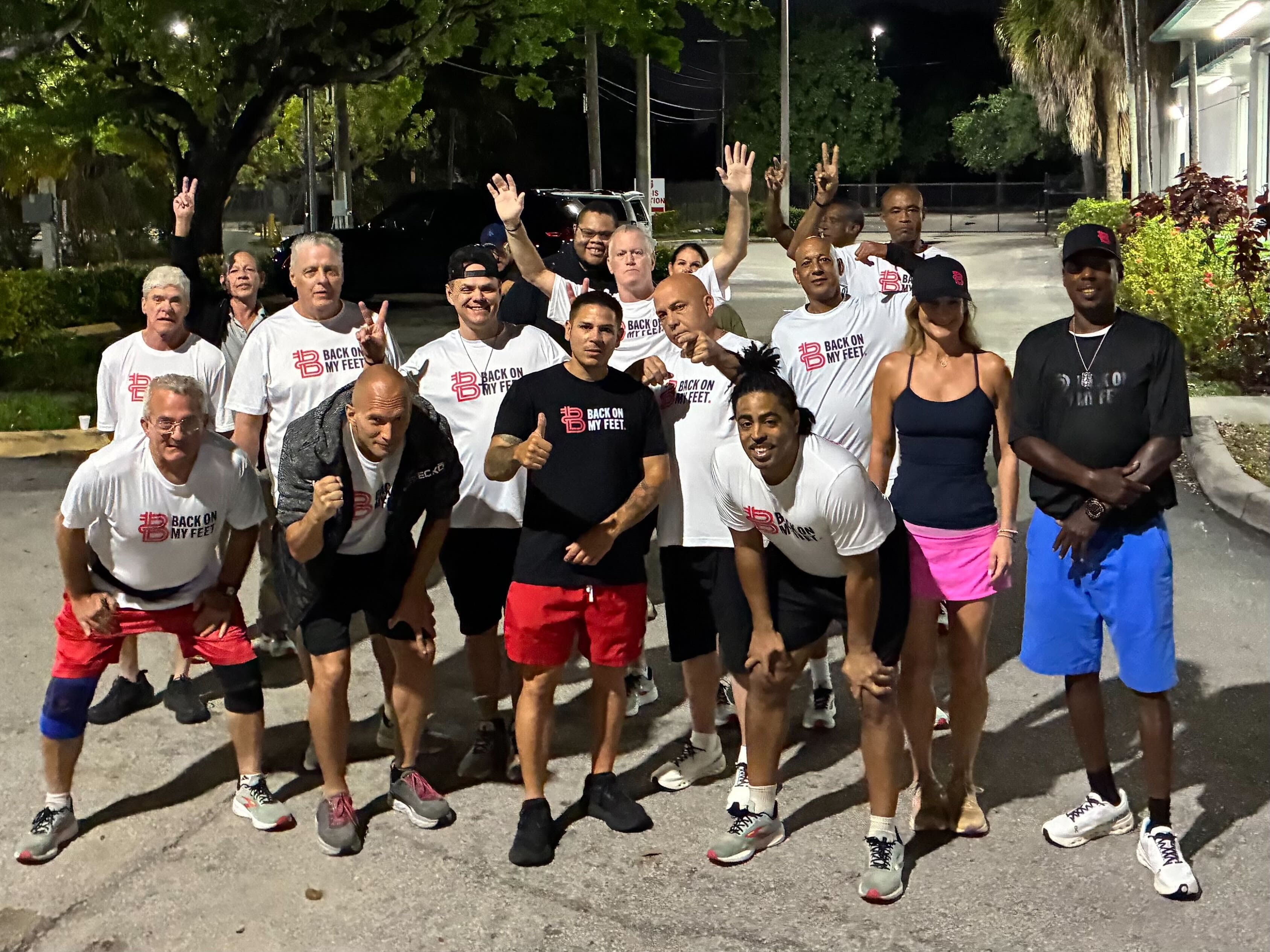 Group of Back on My Feet runners and volunteers posing together outdoors after a morning run