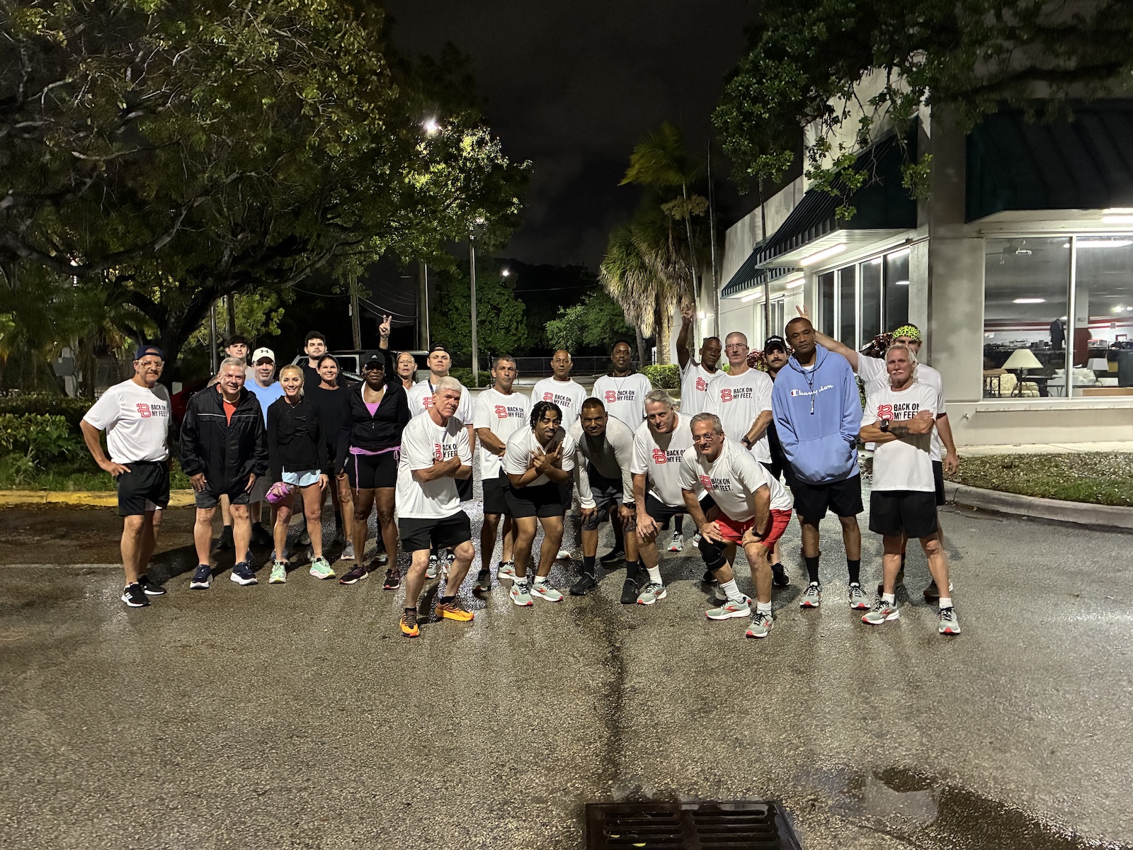 Group of Back on My Feet members walking together down a street at night