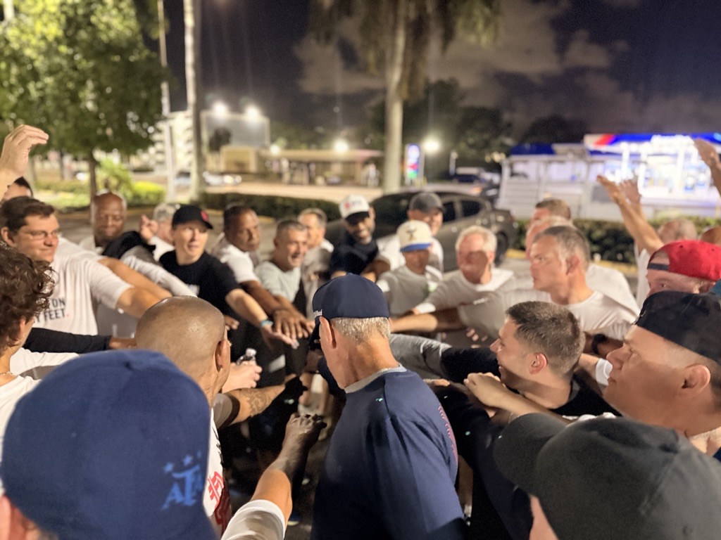 Runners gathered in a huddle before a pre-dawn run