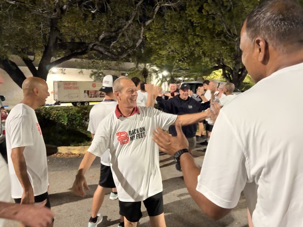 Participants exchanging high fives in a parking lot