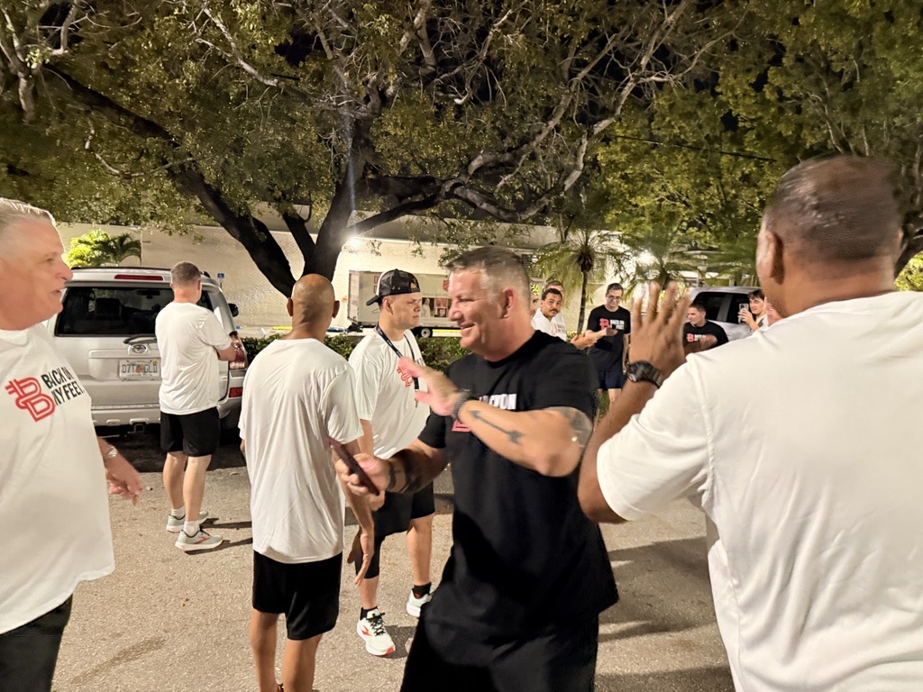 Runners greeting each other with high fives in a circle