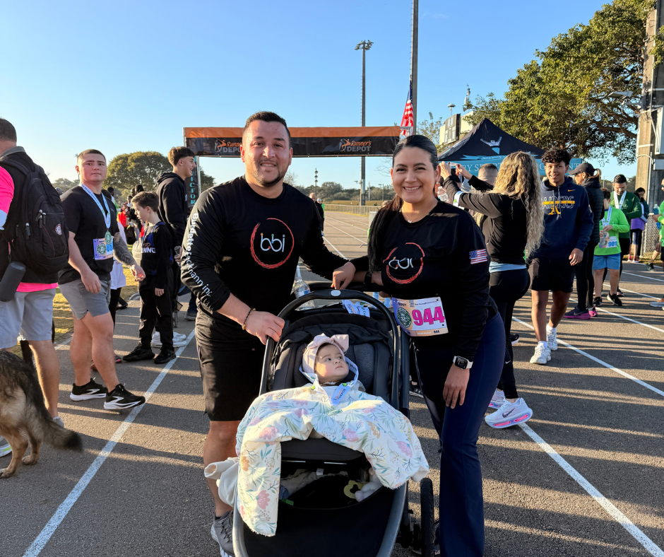 Two BBI runners pushing a stroller