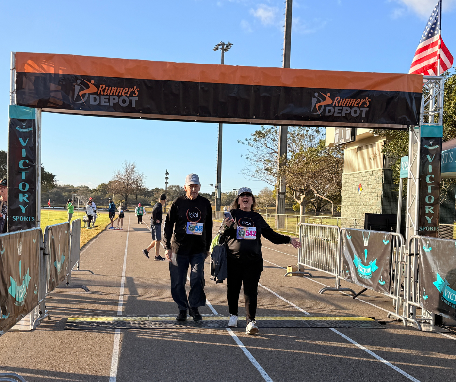 Participants crossing under the finish line arch