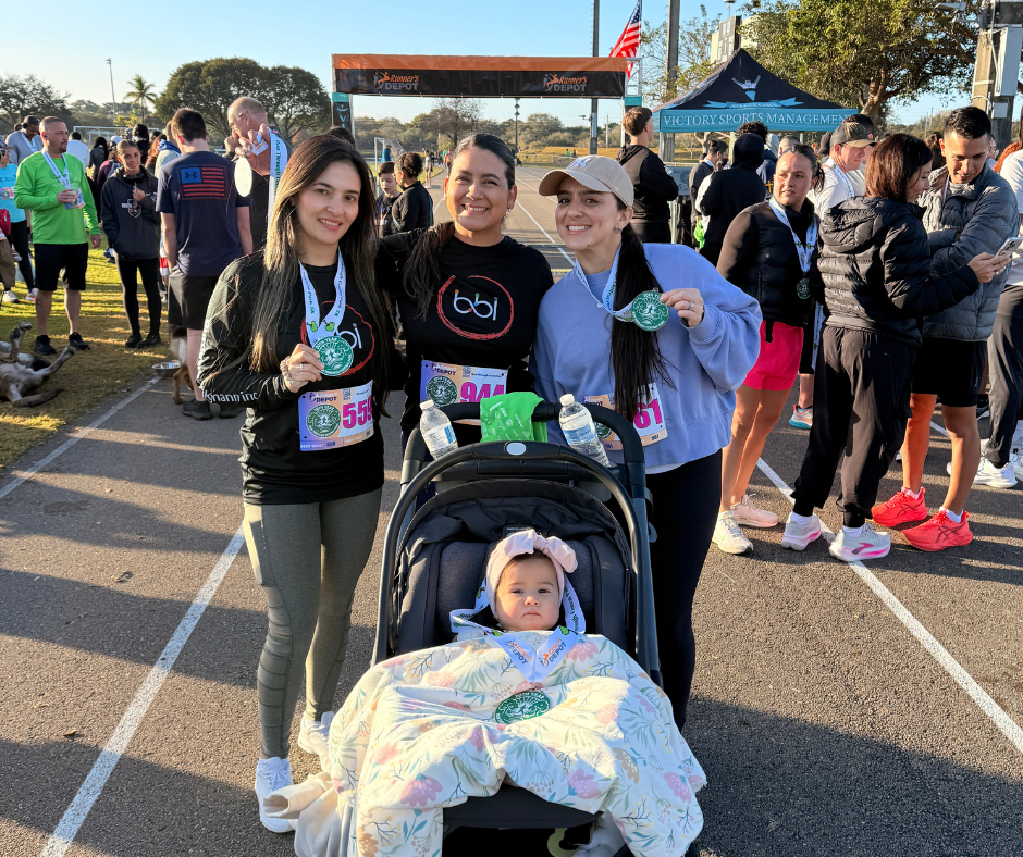 BBI team members with a baby in a stroller