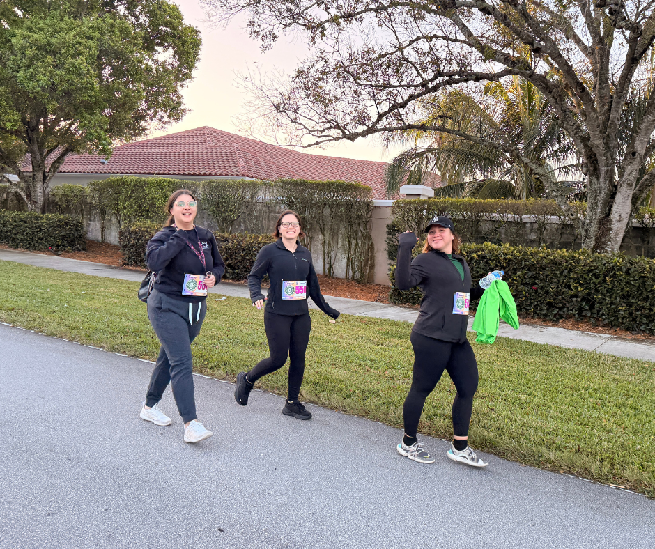 Runners jogging along a path past a house