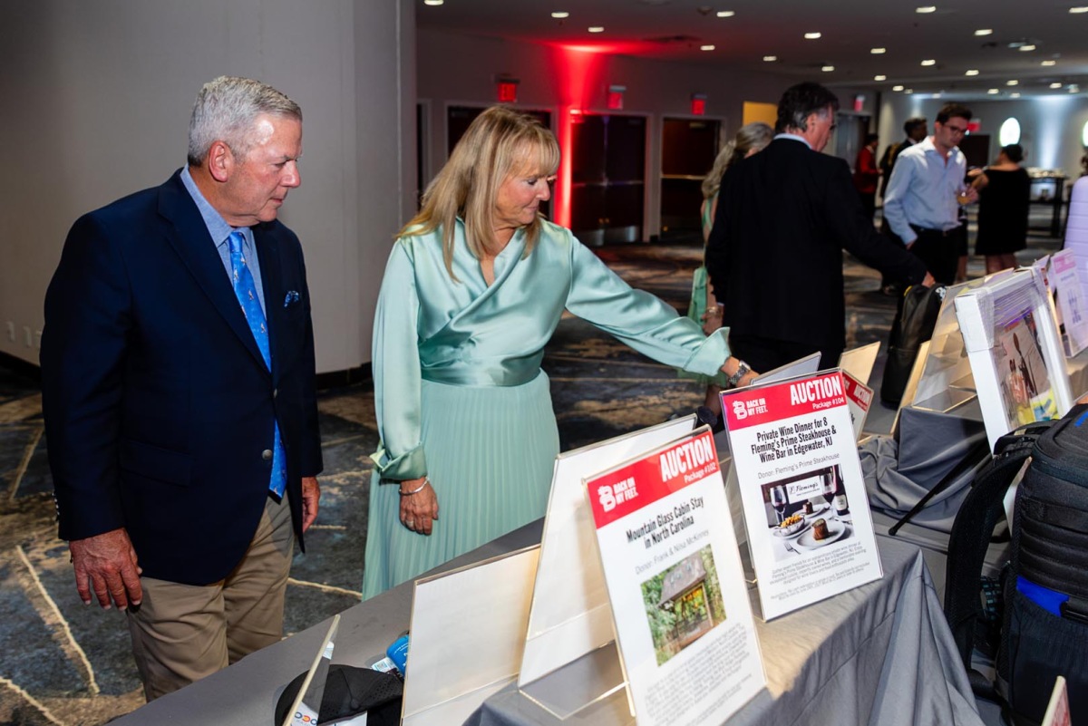 BBI's CEO and a guest browsing the silent auction table