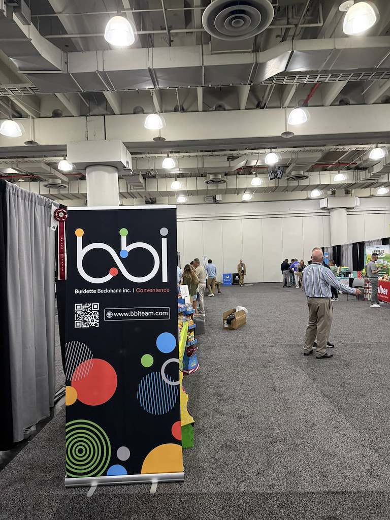 bbi Burdette Beckmann Convenience pull-up banner with a QR code and bbiteam.com address in a trade show hall.