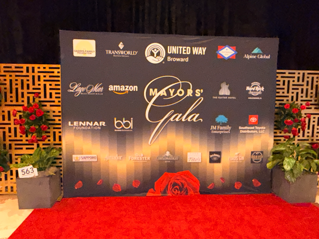 Mayors' Gala backdrop with United Way Broward and sponsor logos including bbi, in front of a red carpet.