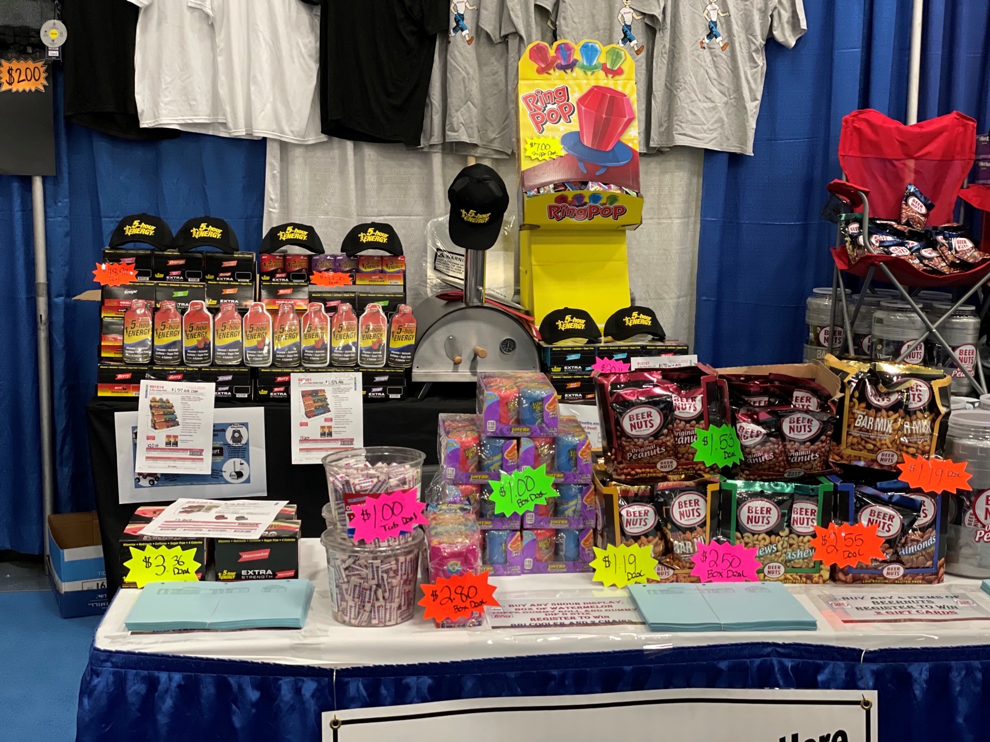Table with 5-hour Energy bottles, a Ring Pop display, bags of Beer Nuts and bright price tags.