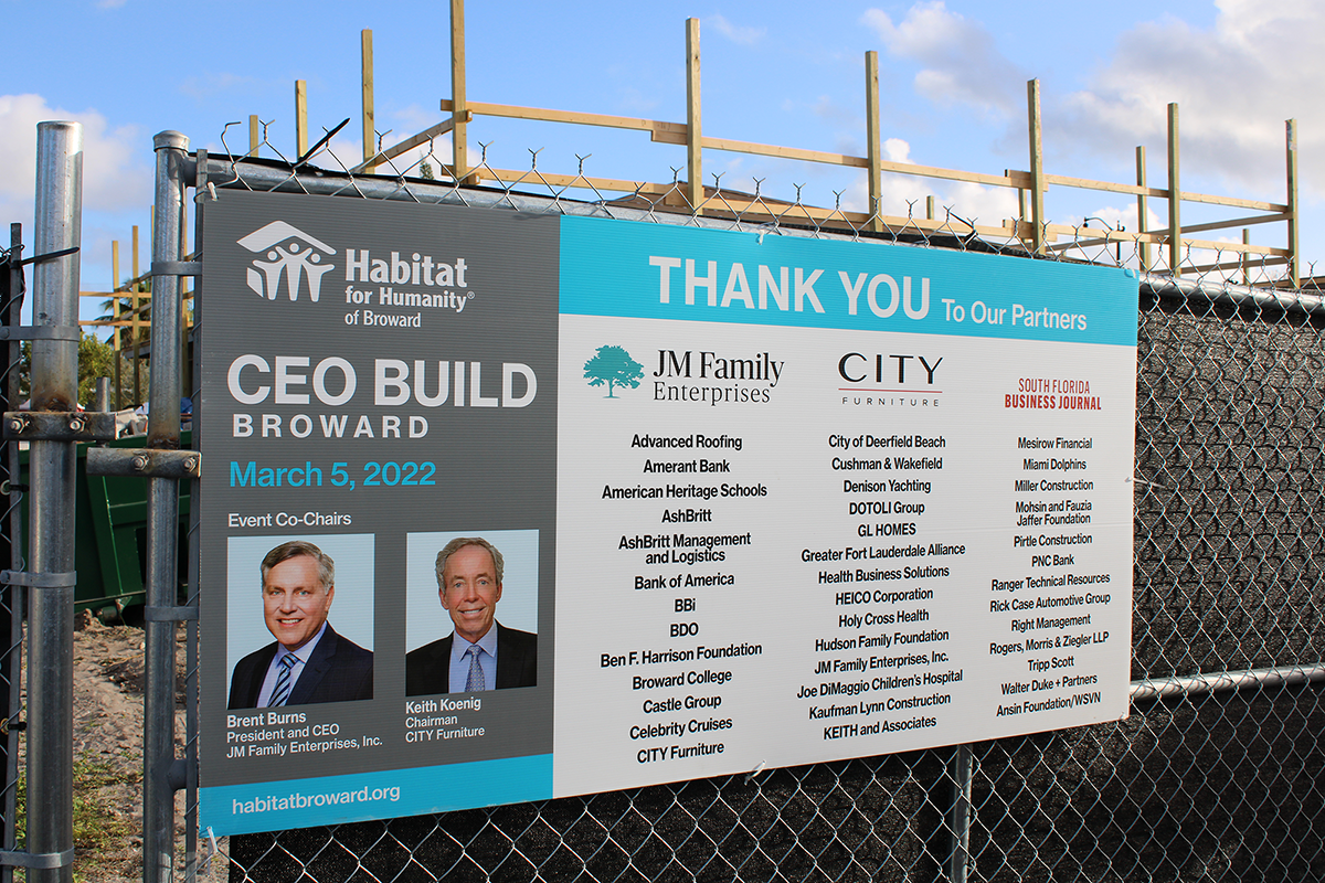 Fence sign reading Habitat for Humanity CEO Build Broward March 5, 2022, thanking partners including BBi.