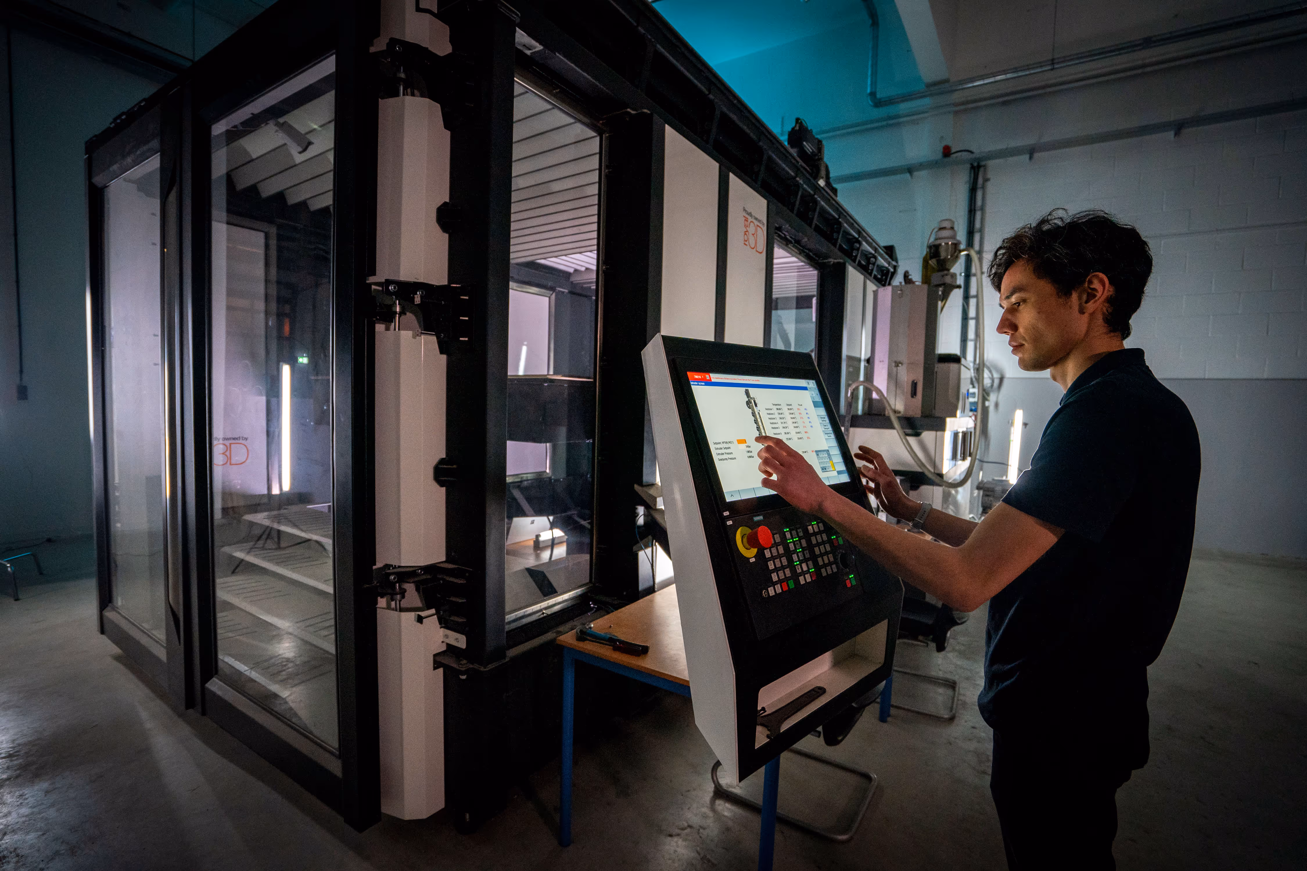 Royal3D engineers preparing the CEAD LFAM 3D printer printer for a new print.
